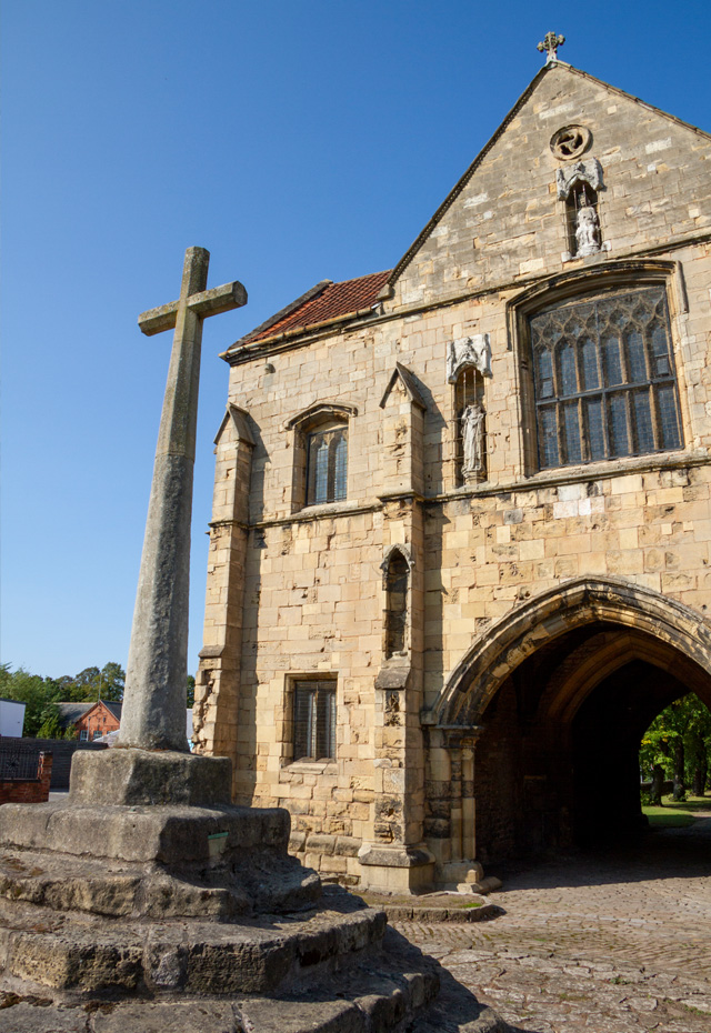 Worksop Priory Gatehouse and relocated marketplace cross